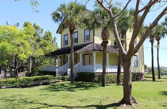 yellow historic home with trees at yesteryear village west palm beach