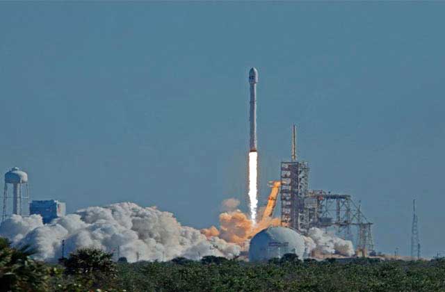 rocket launches with smoke against a blue sky at playalinda beach canaveral national seashore