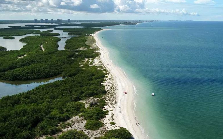 sand jetty with green water and blue sky at cayo costa for fort myers sanibel destination feature