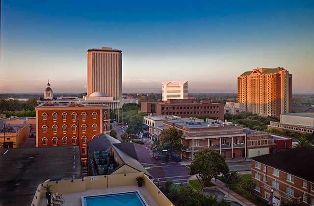 aerial view of downtown city buildings with sunset skyline at tallahassee destination feature