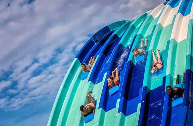 four sliders on mats speeding down steep chutes at island h2o live waterpark kissimmee