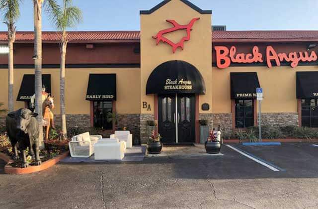 front exterior of restaurant with cow and patio at black angus steakhouse kissimmee