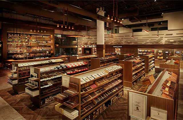 interior of shop with bar and shelves of cigars and liquor bottles at corona cigar company tampa