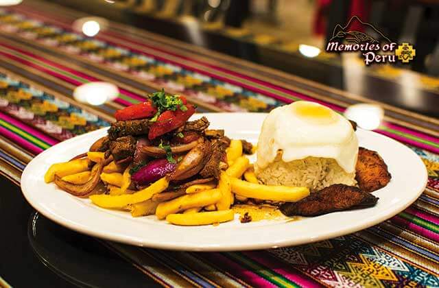 lomo saltado dish with steak stir fry egg fries and plantains at memories of peru restaurant orlando