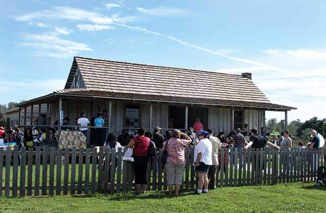 visitors crowd around historic shack at pioneer village shingle creek kissimmee