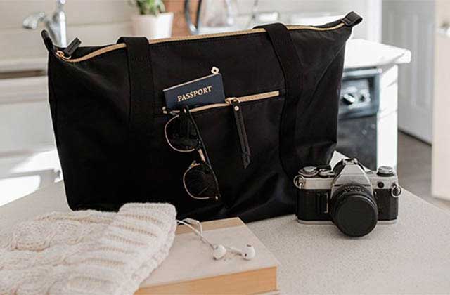 cargo bag with passport sunglasses and camera on kitchen counter at samsonite stores orlando