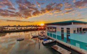 facility on dock with boats and sunset orange sky with clouds at clearwater marine aquarium