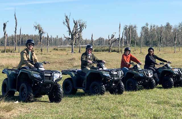 four helmeted atv riders smile at safari wilderness ranch lakeland
