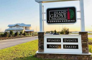 front exterior sign with bottle logo at island grove wine company at formosa gardens kissimmee
