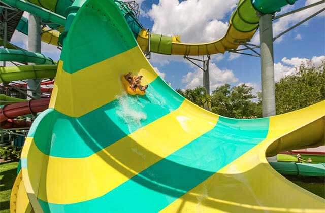 group on a raft sliding along water slide at adventure island tampa bay