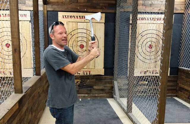 instructor holding axe before throw at axe on axe off throwing venue orlando