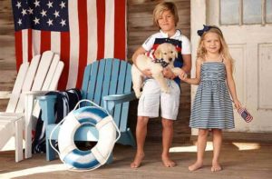 kids with puppy wearing patriotic clothing on a porch for polo ralph lauren factory store orlando