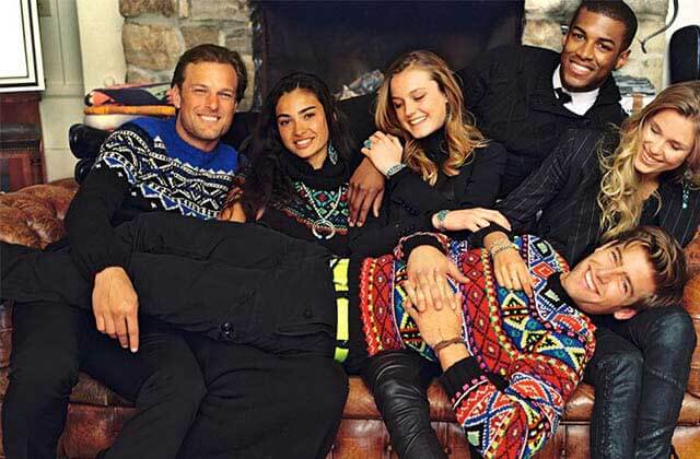 laughing group of models wearing sweaters on a leather sofa for polo ralph lauren factory store orlando