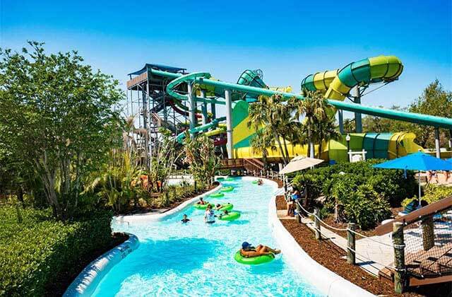 people floating in inner tubes along a lazy river at adventure island tampa bay