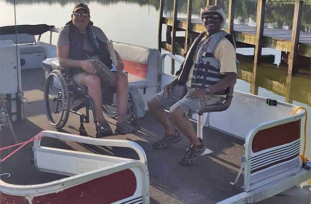 two men one in a wheelchair on pontoon ready to fish at memory makin fishing guides kissimmee