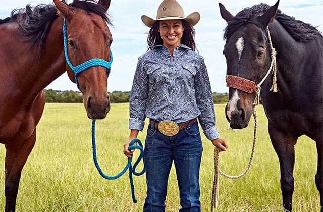 woman in western wear stands between two horses for cavenders western wear orlando