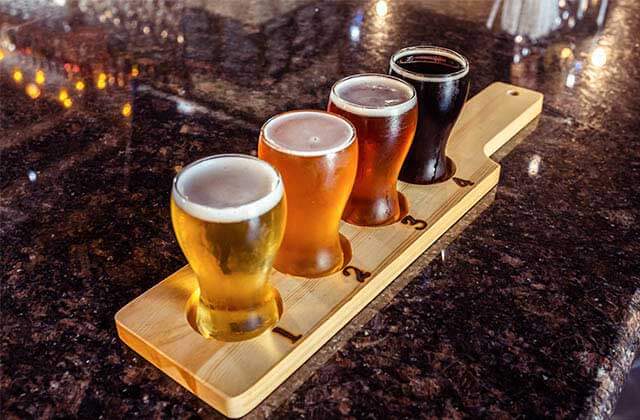 wooden flight of four beer samples at island grove wine company at formosa gardens kissimmee