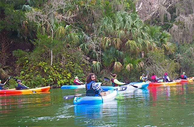 group of kayaks touring a river with trees at the canyons zip line adventure park ocala