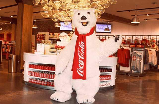 mascot polar bear waving at the store entrance at coca cola store at disney springs