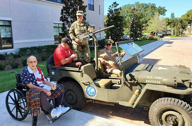 men sitting in an army jeep with a mounted gun at museum of military history kissimmee