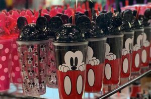 shelf of disney travel cups at treasure island gift shop orlando lake buena vista