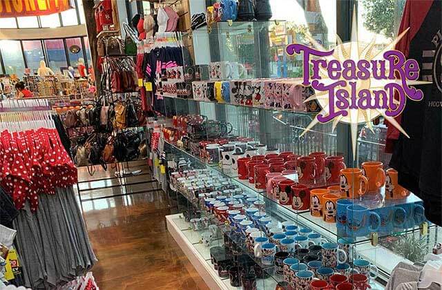 shelves of disney souvenir mugs kids apparel and purses at treasure island gift shop orlando lake buena vista