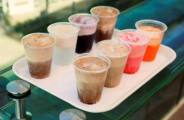 tray of variety of colors of frozen drinks at coca-cola store at disney springs