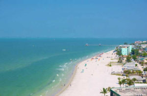 aerial view of beach with palms and a turquoise ocean at fort myers sanibel island beaches