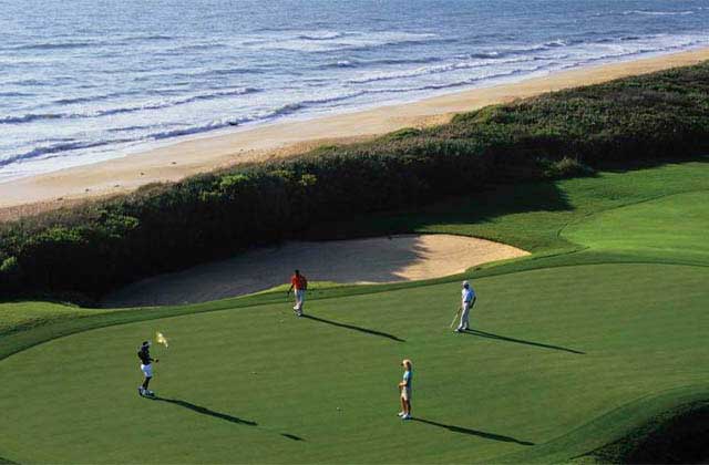 aerial view of golfers on a putting green on the beach at north east beaches