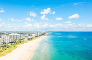 aerial view of shoreline with high rises and crystal blue waters at fort lauderdale beaches