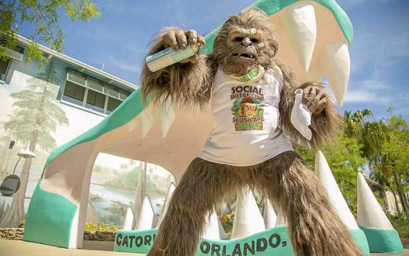 gatorland entrance with ape costume character with sanitizing spray