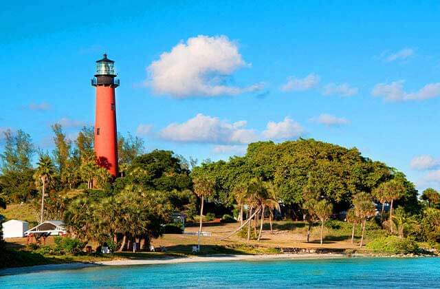 view across the inlet of red lighthouse and trees at south east beaches