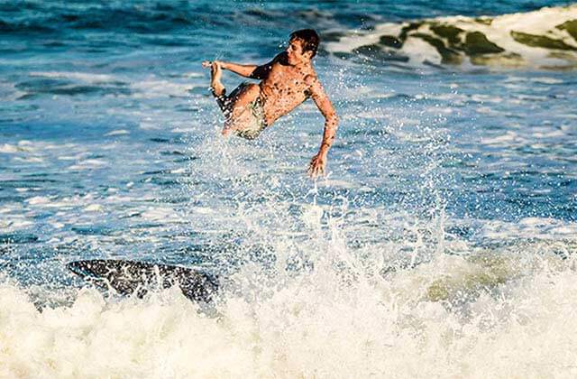 young man surfing with waves and foam at north east beaches