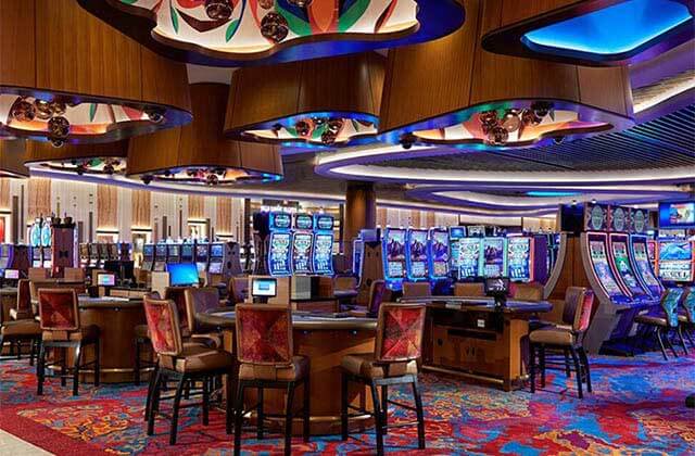 colorful casino floor with slots and dealing tables at seminole hard rock hotel casino hollywood florida
