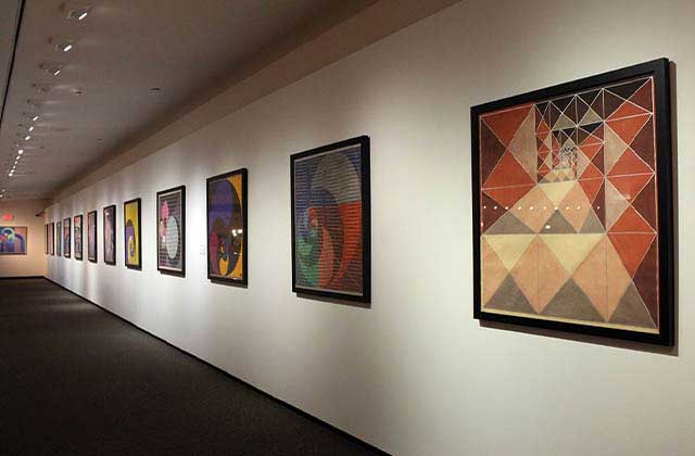 colorful framed pieces of art in a corridor at appleton museum of art ocala