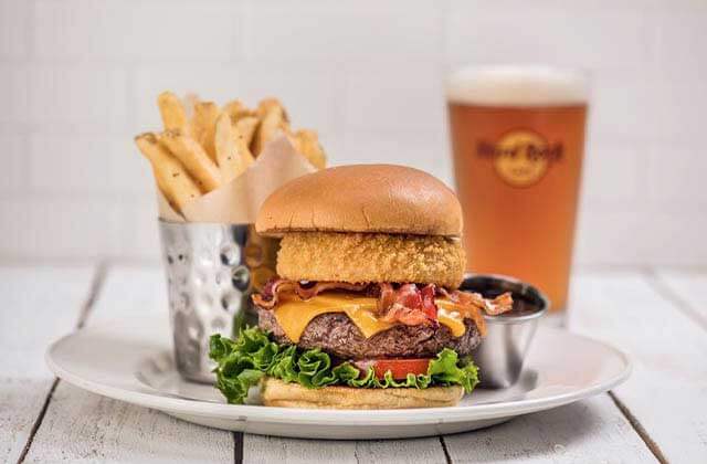 deluxe burger with onion ring with fries and draft beer at hard rock cafe key west