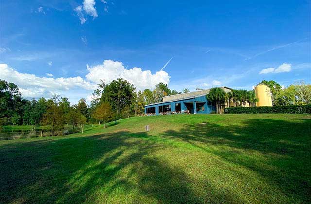 exterior of brewery atop a grassy hill at swamp head brewery gainesville