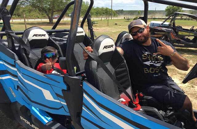 man and boy in four-seated atv at world adventures ocala