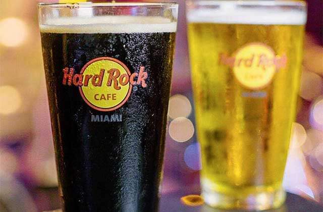 one dark and one light draft beers in brand glasses at hard rock cafe miami