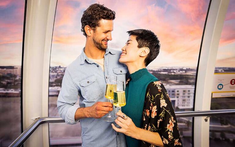 romantic couple with champagne in gondola at the orlando eye icon park