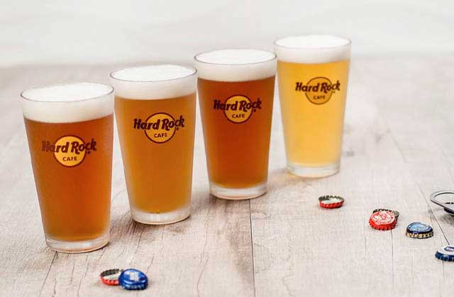 row of draft beers in brand pint glasses at hard rock cafe key west