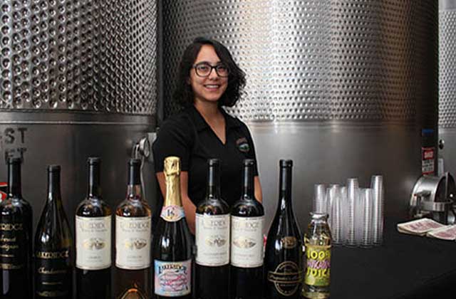 smiling woman serving tasting wines at lakeridge winery vineyards orlando