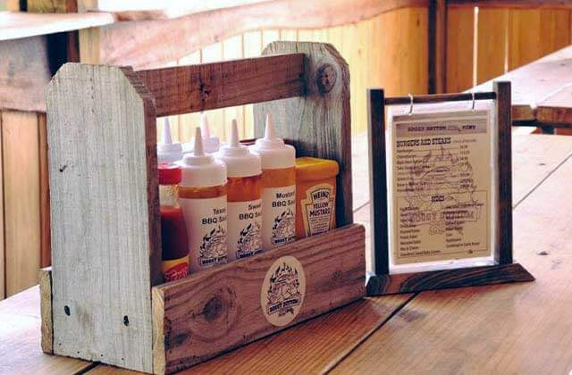 variety of bbq sauces with menu on a wood table at boggy bottom barbecue kissimmee