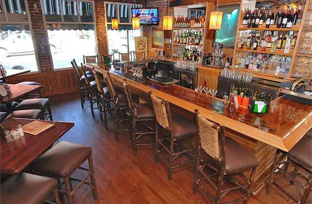 wooden bar area with seating at the great outdoors restaurant high springs