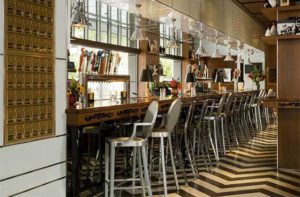 bar seating along a window with classic decor at the office prime burgers craft beer delray beach