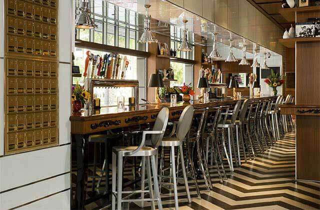 bar seating along a window with classic decor at the office prime burgers craft beer delray beach