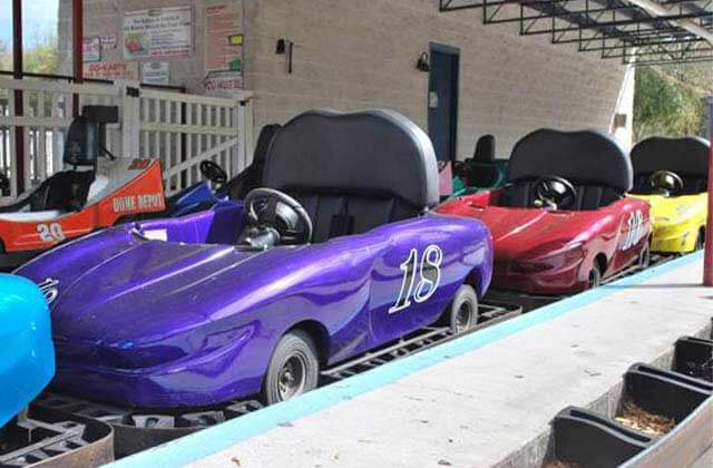 blue purple red and yellow go karts lined up on a track at easy street by funworks ocala