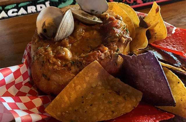 bread bowl with seafood stew tortilla chips and clams at sandbar sports grill