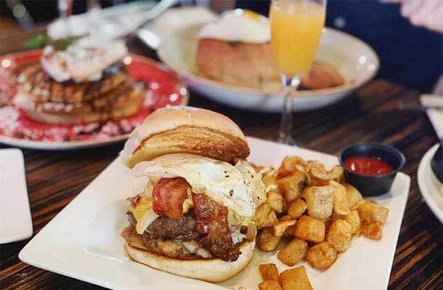 burger with egg entree mimosa pancakes and other brunch items at the office prime burgers craft beer delray beach