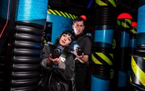 couple playing laser tag in arcade area at wonderworks panama city beach